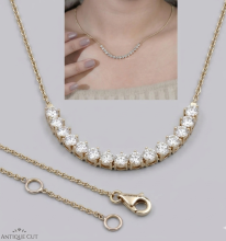 Delicate yellow-gold necklace featuring a curved row of round brilliant-cut clear gemstones in prong settings, suspended on a fine chain. The necklace is shown in close-up against a light gray background, with an inset photo demonstrating how it sits elegantly along the collarbone when worn. A lobster clasp and adjustable chain rings are visible.