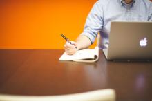 https://www.pexels.com/photo/man-using-macbook-while-holding-pen-7061/