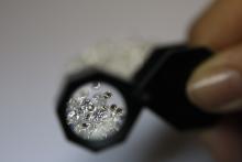 Loose diamonds viewed through a jeweler's magnifying loupe